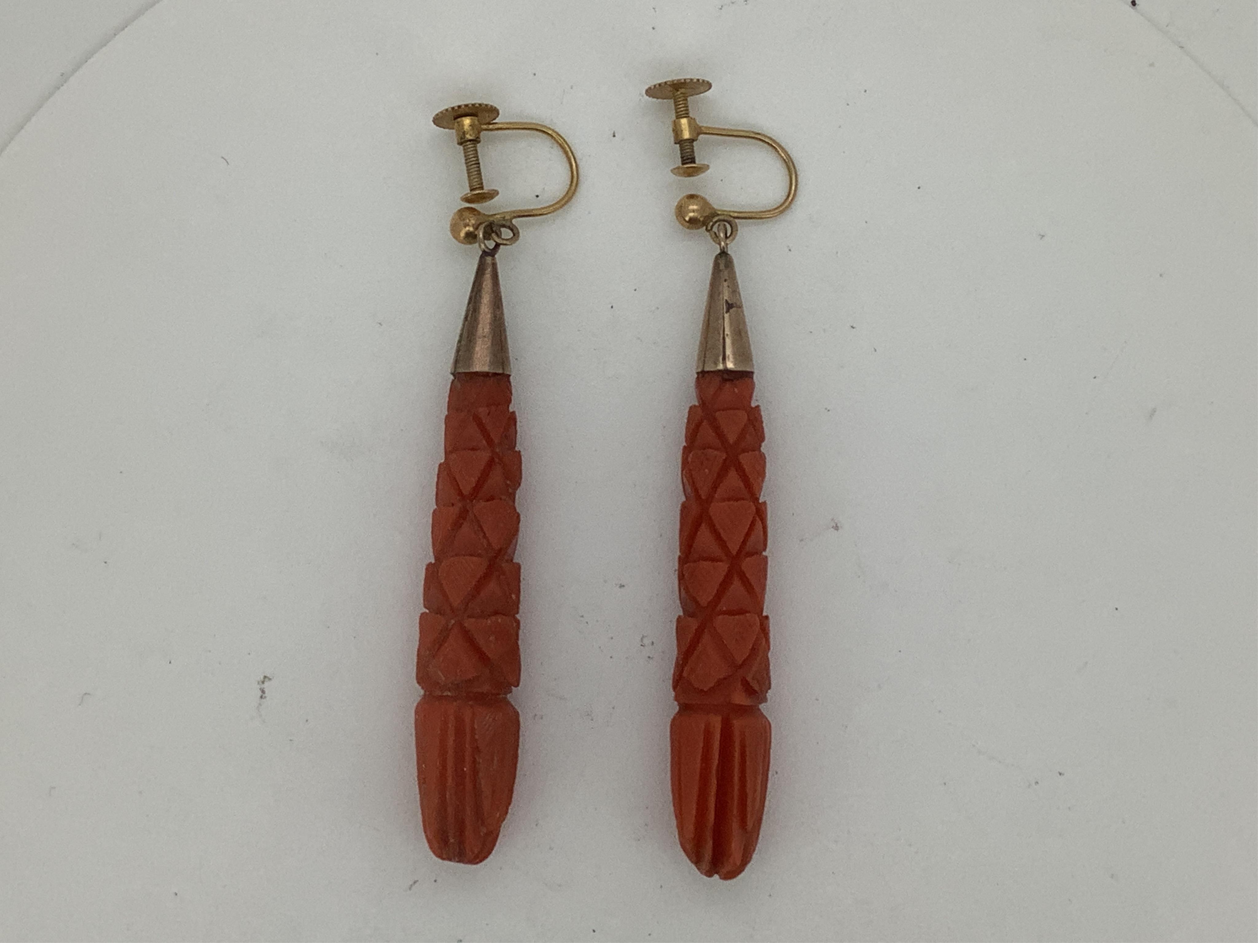 A pair of Victorian coral drop earrings, late 19th century, each composed of elongated coral drops carved with stylised foliate designs, to later screw fittings, length approximately 5.9cm